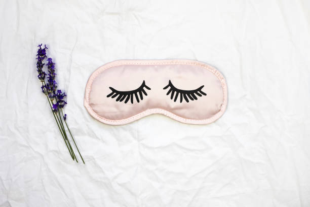istock Sleep mask with natural lavender on a white sheet. Top view, place for text . 1332564676