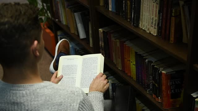 Student in the library searches for literature