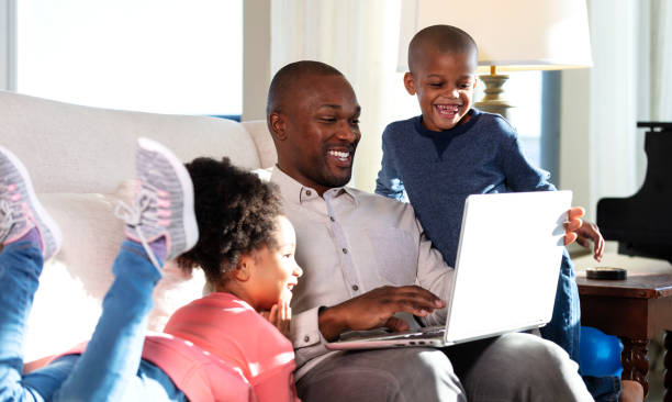 istock Father working at home on laptop, laughing with children 1332565590