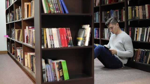Student in the library searches for literature