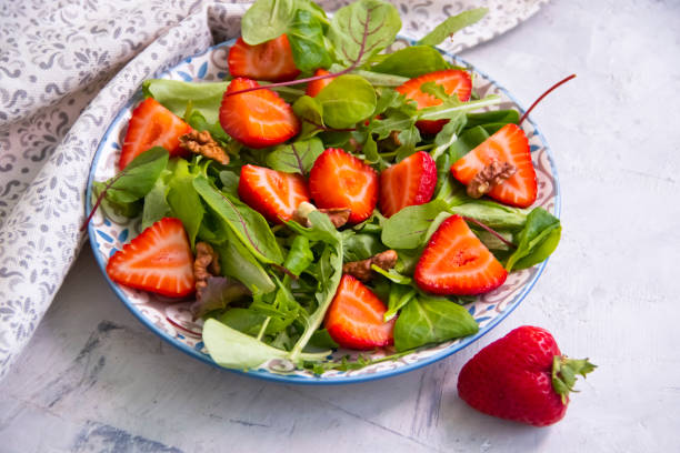 istock green lettuce leaves, strawberries, nuts on a plate 1332568374