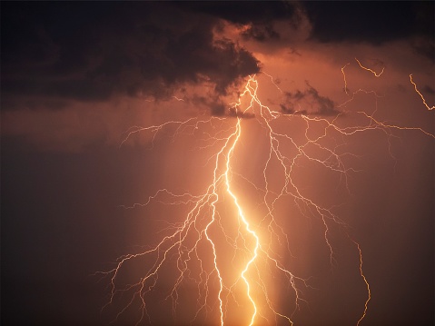 Night photo of a thunderstorm on a long exposure, close up. A composite image of several frames. Copy space, an effect for design and overlay.