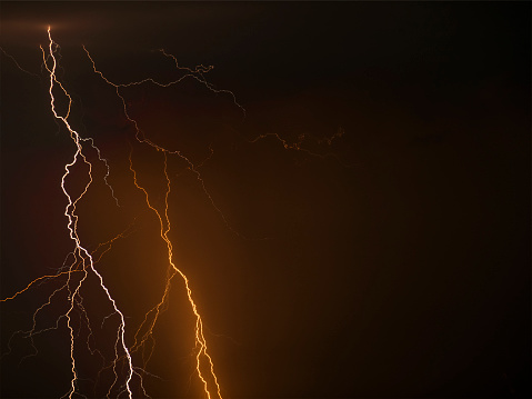Night photo of a thunderstorm on a long exposure, close up. A composite image of several frames. Copy space, an effect for design and overlay.