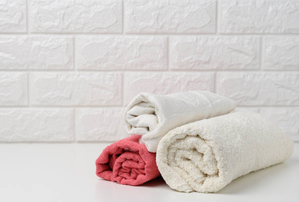 istock clean white rolled terry towels on white shelf, bath interior 1332573604