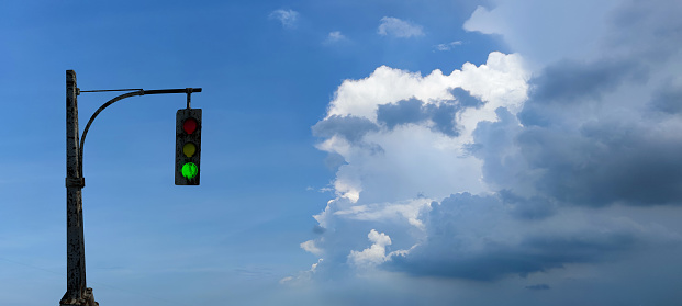 The traffic lights against a vibrant blue sky