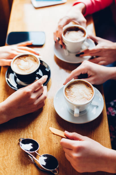 istock Close Up Of Hands With Coffee Cups 1332575366