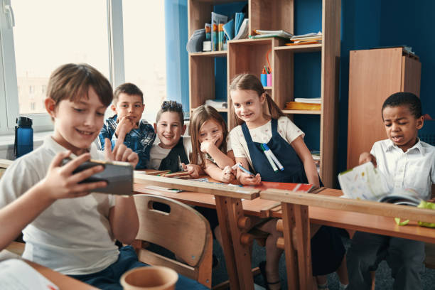 istock Friendly classmates trying to take selfie together 1332576714