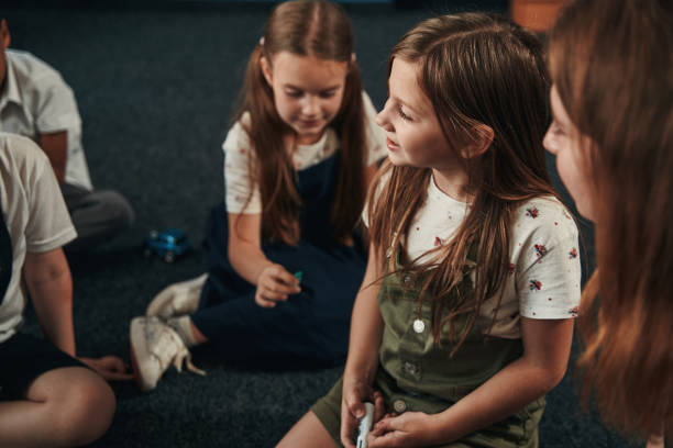 istock Elementary pupils having good time together at school 1332576759