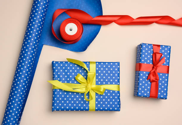 istock blue gift box wrapped in silk ribbon on a beige background 1332578635