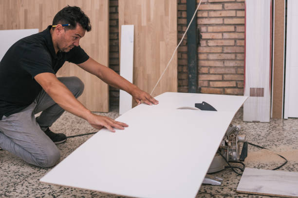 istock Unprotected man cutting a surface with an electric disc in a workshop 1332584129