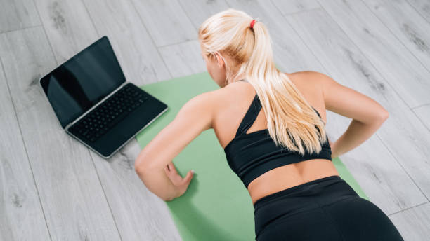 istock strong body female trainer online training home 1332585188