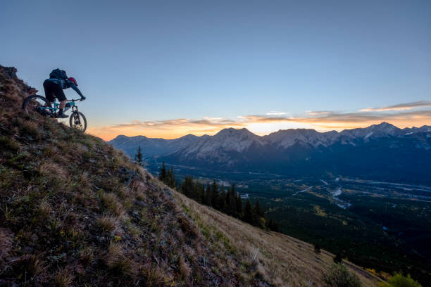 istock View of mountain biker descending mountain ridge 1332588521