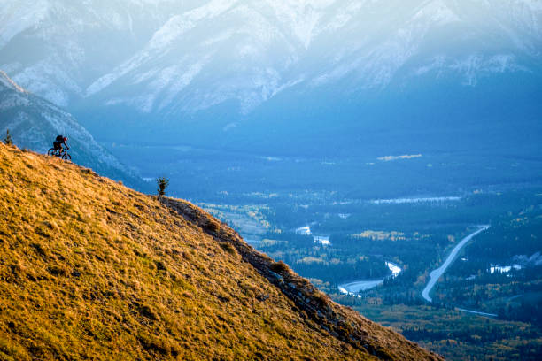 istock View of mountain biker descending mountain ridge 1332588578