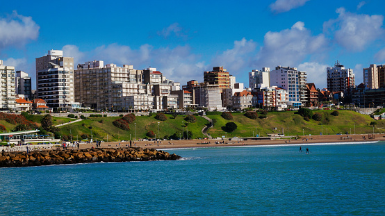 Mar del Plata, Argentina- July 26, 2021: Panoramic view of Mar del plata city, buildings and beach taken from the ocean on a sunny winter morning under a blue sky with a few clouds