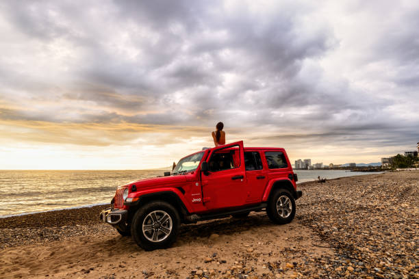 Jeep Wrangler Sahara Unlimited PuertoVallarta, Jalisco, Mexico - 07 \ 27 \ 20 : The 2019 Jeep Wrangler Unlimited Sahara off-road with the ocean and cityscape in the background jeep stock pictures, royalty-free photos & images