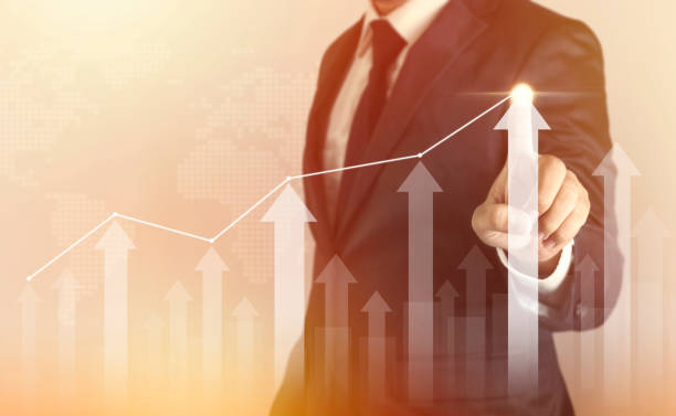 istock Growth success developments to goals concept. Businessman forecast analysis plan profit chart with finger and increase of positive indicators 1332593116