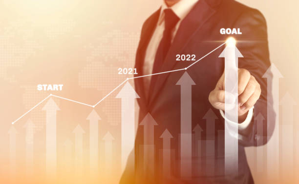 istock Growth success developments to goals concept. Businessman forecast analysis plan profit chart with finger and increase of positive indicators 1332593129