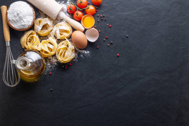 istock Mixed dried pasta selection on black stone background 1332593234
