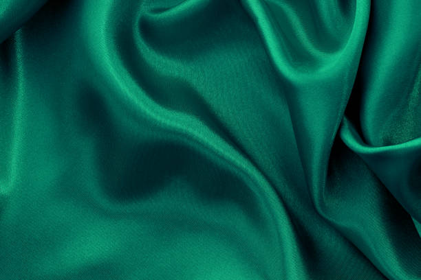 istock Green fabric texture background, detail of silk or linen pattern. 1332594972