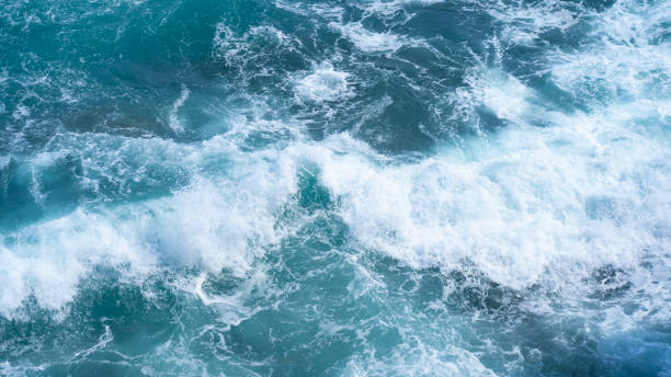 istock Image of waves hitting rocks 1332595033