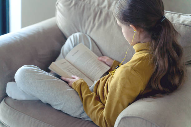 istock Young Girl Reading a Book 1332597886