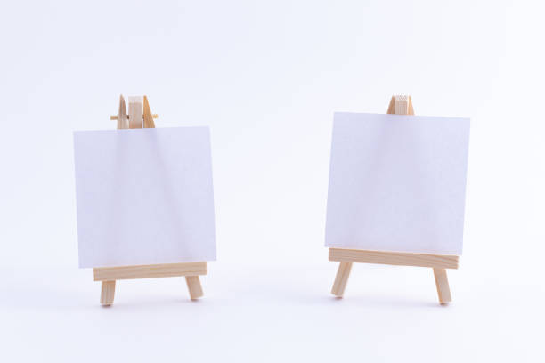 istock Two Wooden Easels Miniature with Blank White Square Canvas 1332598005