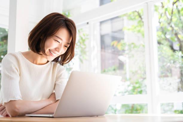 istock young asian woman using laptop 1332598751