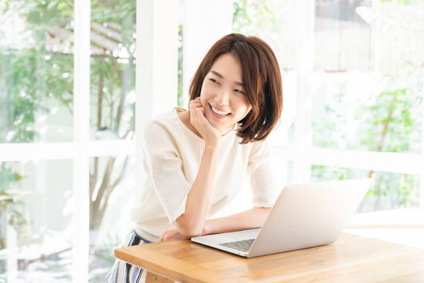 istock young asian woman using laptop 1332598795