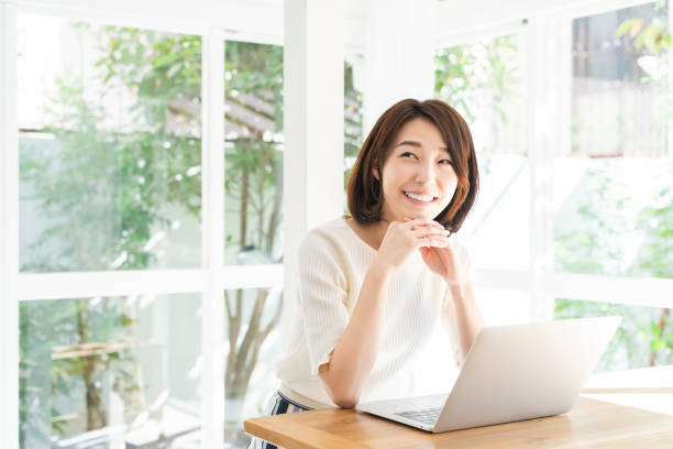 istock young asian woman using laptop 1332598808