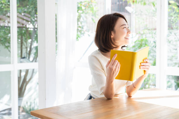 istock attractive asian woman who reads a book, 1332598819