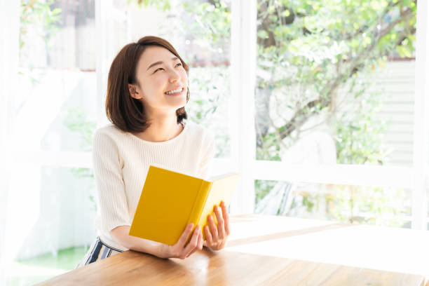 istock attractive asian woman who reads a book, 1332598824
