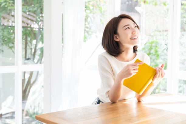 attractive asian woman who reads a book,