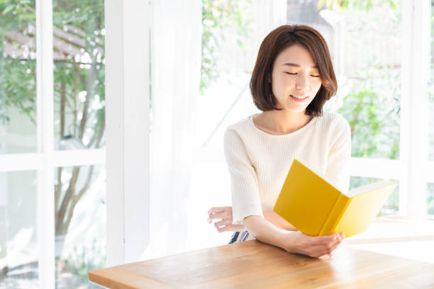 istock attractive asian woman who reads a book, 1332598841