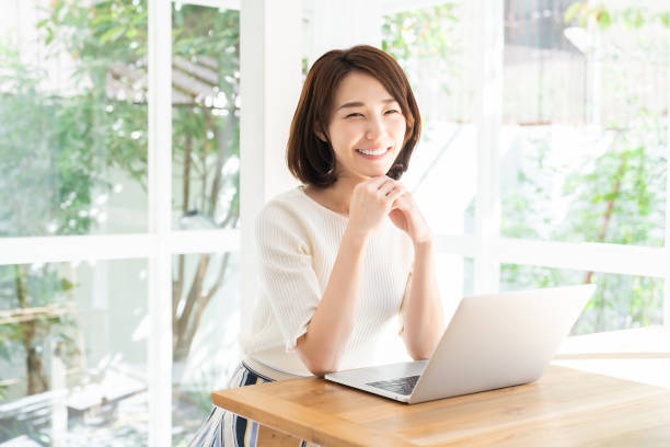 istock young asian woman using laptop 1332598842