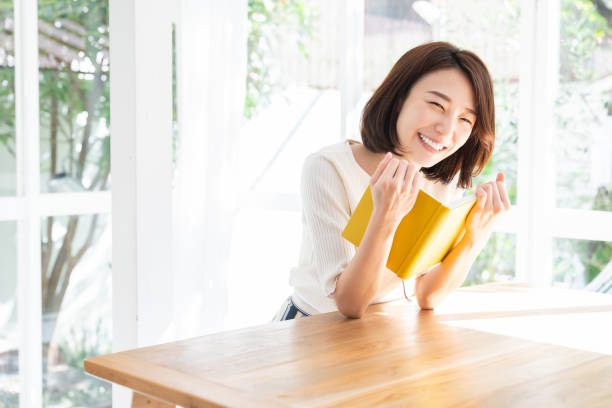 istock attractive asian woman who reads a book, 1332598844