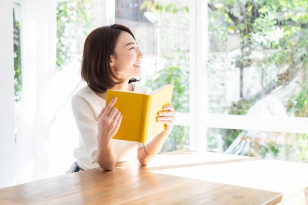 istock attractive asian woman who reads a book, 1332599366