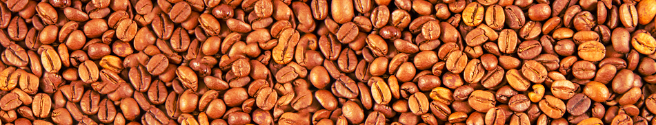 Coffee beans texture, grain close-up, brown background.