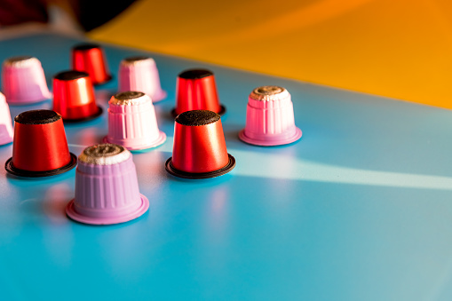 Closeup of a variety of large coffee capsules for a coffee machine.