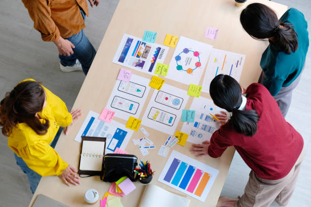 istock Brainstorm planing creative asian teamwork, Group of asia mobile phone app developer team meeting for ideas about screen display prototype smartphone layout, ux startup small business, top view 1332612555