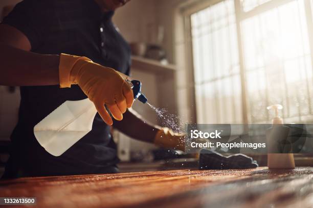 Shot Of An Unrecognisable Man Disinfecting A Kitchen Counter At Home Stock Photo - Download Image Now