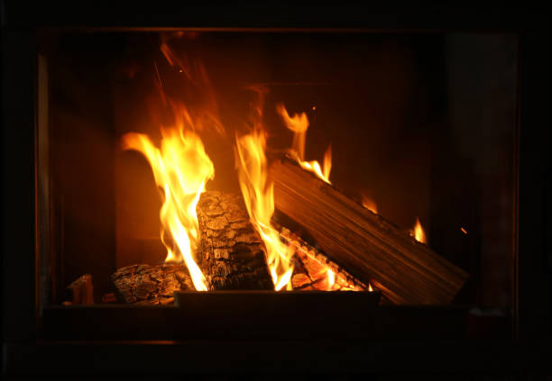 istock Fireplace with burning wood, closeup view. Winter vacation 1332615545