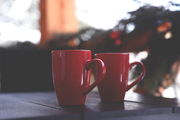 istock Red cups on wooden table outdoors. Winter vacation 1332615599