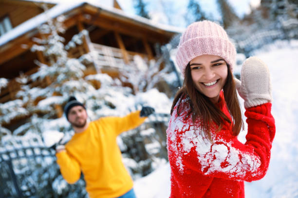 istock Happy couple playing snowballs outdoors. Winter vacation 1332615656