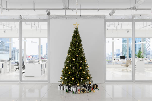 istock Christmas Tree With Ornaments And Gift Boxes In Front Of White Blank Wall In Open Plan Office With Cityscape Background 1332615671