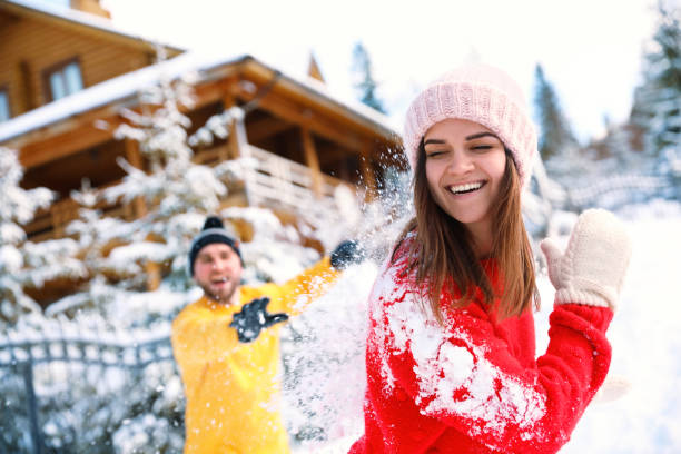 istock Happy couple playing snowballs outdoors. Winter vacation 1332616333