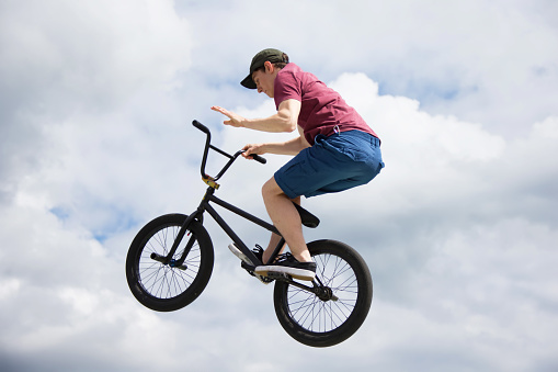 Extreme driving a bicycle.Man on a sports bike against the sky