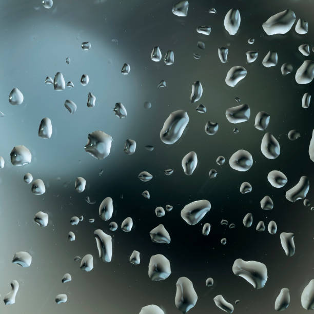 istock Abstract image of water droplets on glass surface reflecting with multicolored background. 1332619410