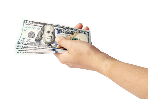istock US dollars in hand isolated on white. woman's hand holds one hundred dollar 1332620156