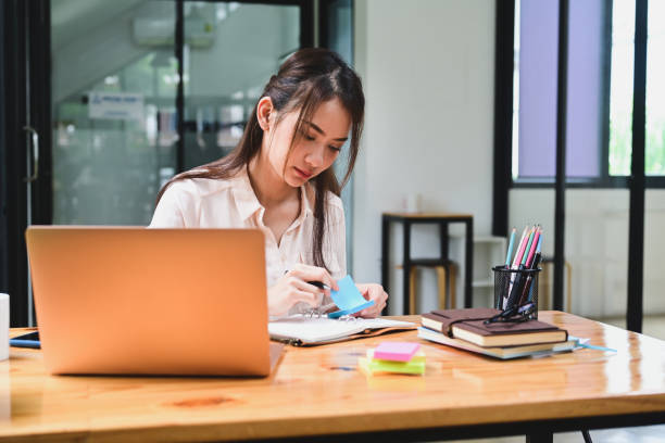 istock Young Asian woman working with laptop computer in office. 1332621223