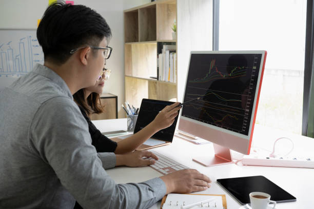 istock Business team discussing and analyzing graph stock market trading with computer. 1332621292